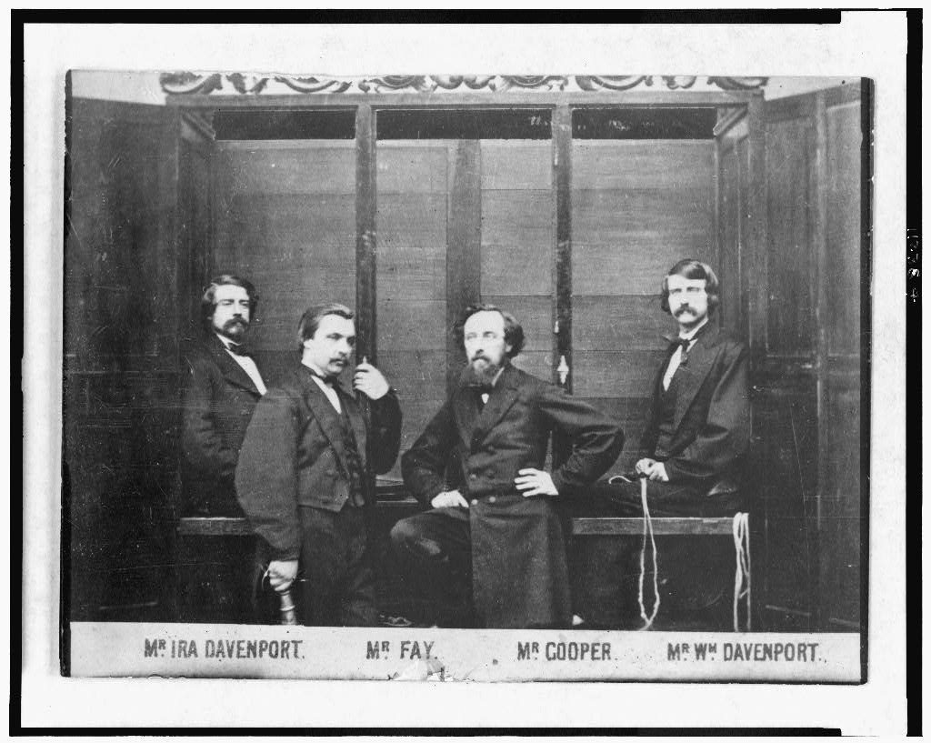 The Davenport Brothers and William Fay with their spirit cabinet. Source: The Library of Congress.